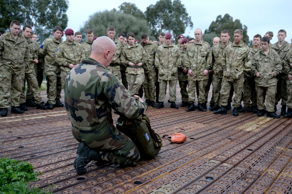 British paratroopers being instructed in how to fit a French parachute 