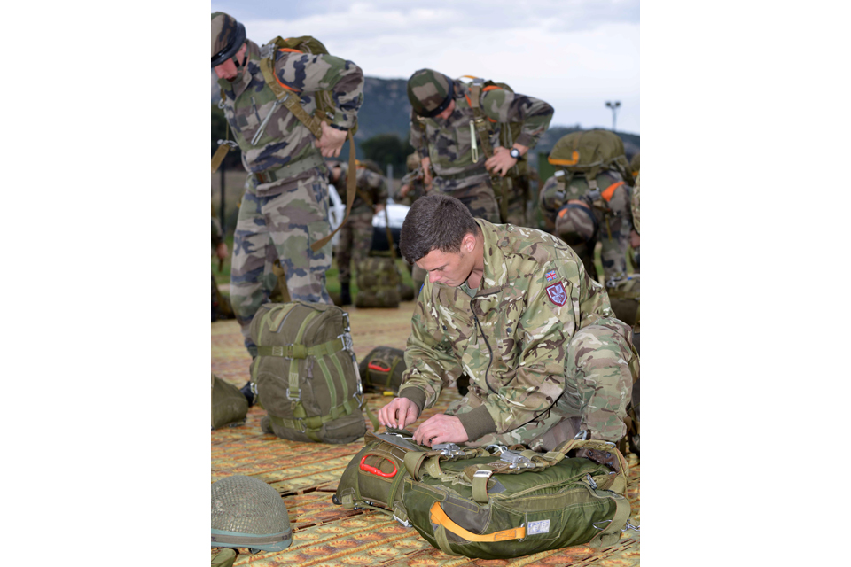 Paratroopers preparing their parachutes