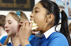 A school girl eating a sandwich