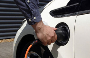 Man charging electric car