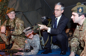 Officer cadets watch Dr Murrison go through weapon drills with an SA80 rifle [Picture: Crown copyright]