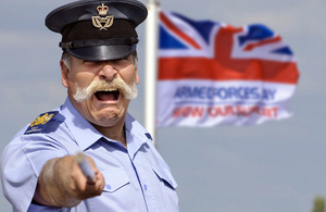 A Royal Air Force warrant officer with the Armed Forces Day flag (library image) [Picture: Paul Crouch, Crown copyright]