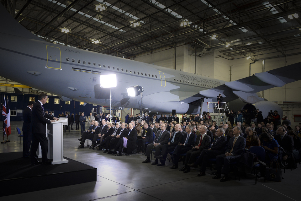 David Cameron and Francois Hollande giving a press conference to a seated crowd.