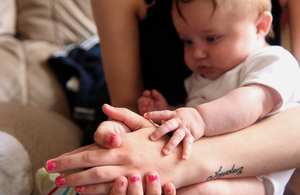 A young mum with a baby on her lap