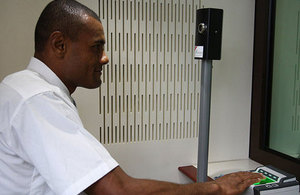 A visa applicant providing his biometrics at the British High Commission in Suva