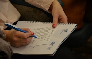 Participant is making notes during the conference