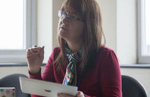 Lady talking holding a tablet computer