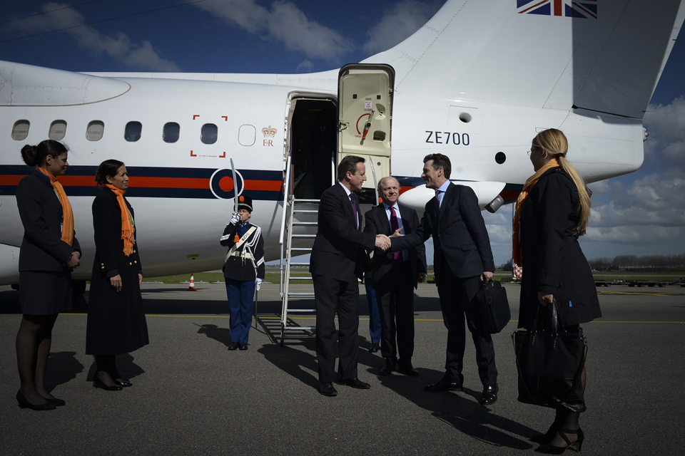 David Cameron getting off a plane and meeting officials.