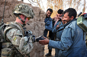 A British soldier shares a joke with members of the Afghan police during a patrol (library image) [Picture: Corporal Mike O'Neill, Crown copyright]