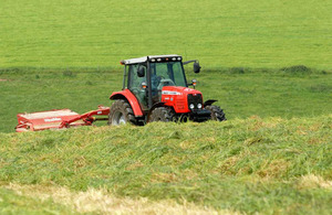 Photograph of a farmer in a tractor.