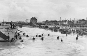 Troops of 9th Canadian Infantry Brigade disembarking with bicycles from landing craft onto Nan White beach on 6 June 1944 [Picture: Imperial War Museum A 23938]