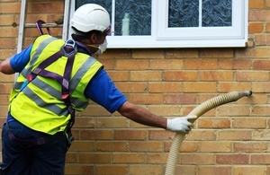 Insulation being pumped in to the wall of a house.