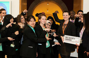 Representatives from the Naz Legacy Foundation, and children, hold up their Big Society Award.