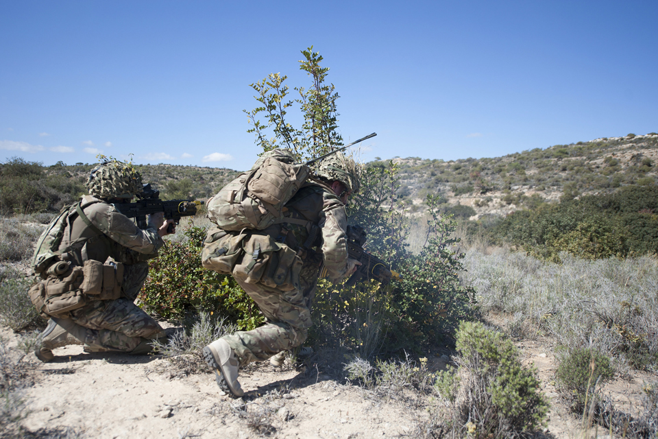 A reservist soldier provides covering fire as his colleague breaks cover