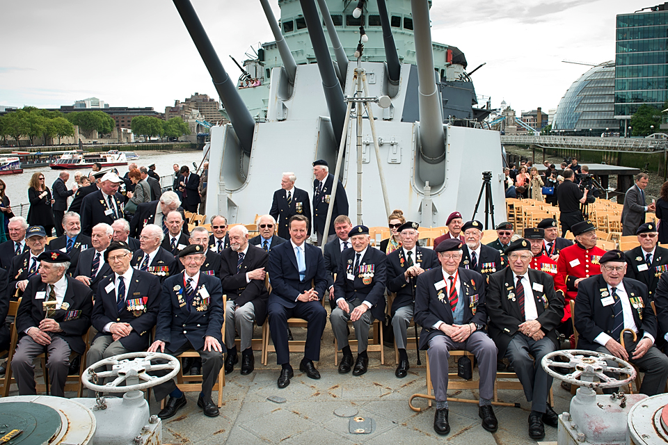 David Cameron poses for a group photo with veterans
