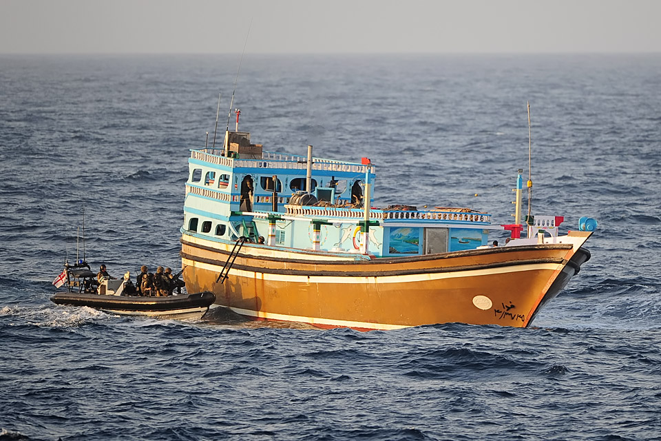 Royal Navy personnel board the dhow