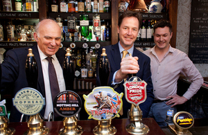 Nick Clegg and Vince Cable behind a bar.