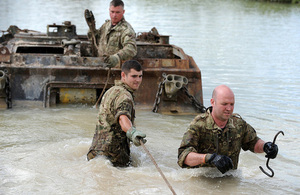 Royal Electrical and Mechanical Engineers reservists work to extract a vehicle from a lake [Picture: Shane Wilkinson, Crown copyright]