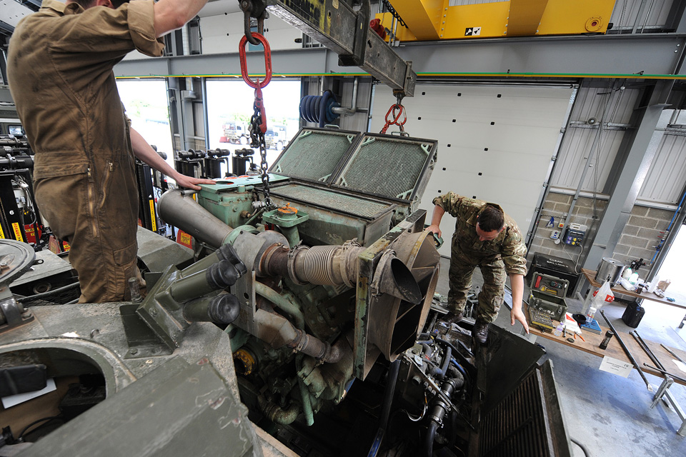 Reservist army vehicle mechanics fit an engine block