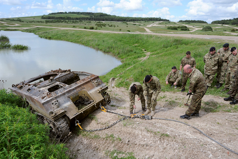 Army reservists work to extract a vehicle from a lake