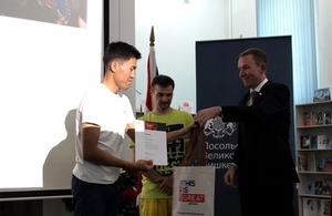 Acting Deputy Head of Mission Martin McKenna awards one of the winners.