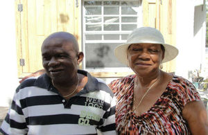 Contractor Norman Parker with beneficiary Patsy Taylor. Her home is receiving new storm shutters, garbage house and cistern.