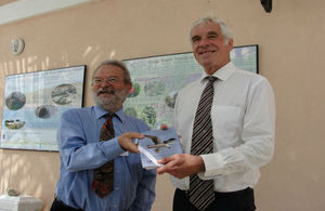 Governor Beckingham (right) is presented with a full set of the booklets by Dr Mike Pienkowski.