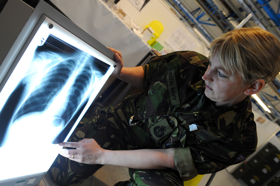 A Royal Navy medic examines an X-ray