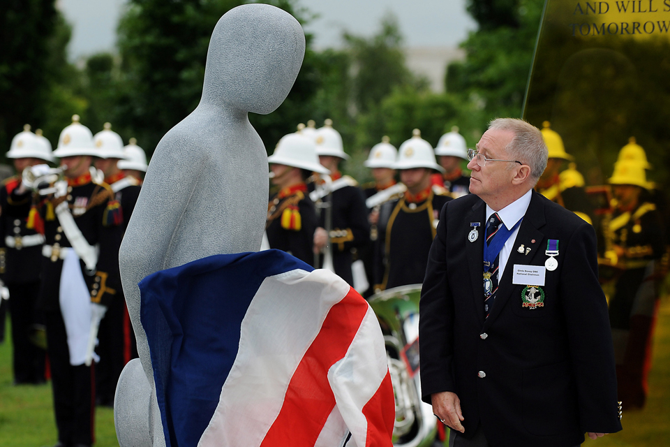 The figure of a sailor is unveiled by the chairman of the Royal Naval Association