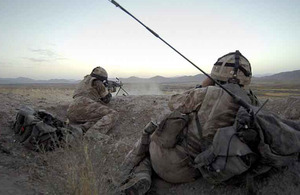 A soldier from 1st Battalion The Royal Anglian Regiment fires a 'Minimi' Light Machine Gun, while another directs his fire, during operations in Kajaki, Helmand province, in 2007 (stock image)