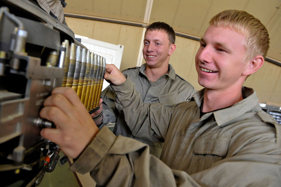 Brothers Staff Sergeant Ray Neenan and Corporal Darren Neenan loading 30mm rounds for the Apache attack helicopter's formidable Hughes M230 chain gun