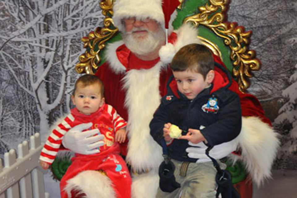 Children of a 16 Air Assault Brigade soldier on operations in Afghanistan sit on Santa's knee