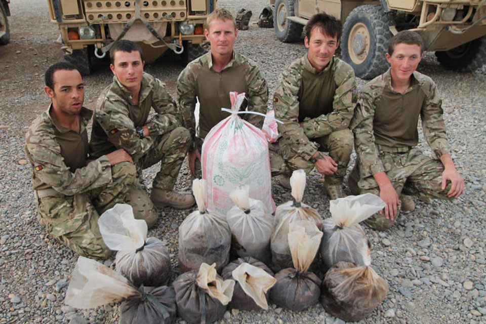 British soldiers with bags of seized drugs and explosives. Left to right: Private Otis Tait, Private John Adcock, Sergeant Terry Johnson, Corporal Jamie Seymour and Private Bellingham