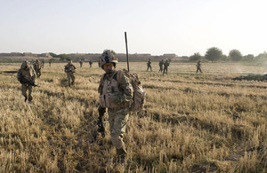 Gurkhas from C Company, 1st Battalion The Royal Gurkha Rifles, and soldiers from the Afghan National Army cross a recently harvested field during a joint patrol in the Nahr-e Saraj region of Helmand province (stock image)