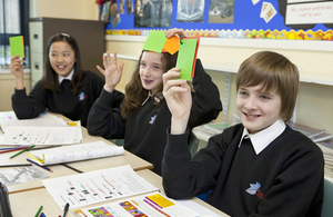 students raising coloured cards in class