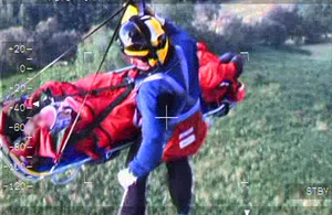 An RAF Search and Rescue crewman and the 74-year-old walker are winched up to the Sea King helicopter at Helvellyn Fell