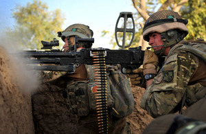 Best Operational Image - Ranger Pete Mawhinney, 1st Battalion The Royal Irish Regiment, returns fire with his general purpose machine gun after insurgents attempt to ambush his patrol in Helmand province