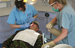 Lieutenant Colonel Jo Loudon and dental nurse Gwen Sanderson work on a 16 Air Assault Bridgade soldier's teeth