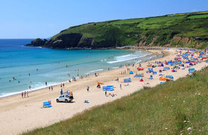 Sunny beach with lots of people sun bathing