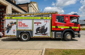 Fire engine with 'How to train your family' poster