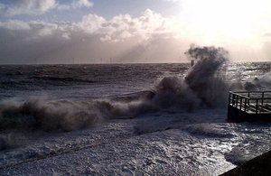 Waves crashing over sea wall