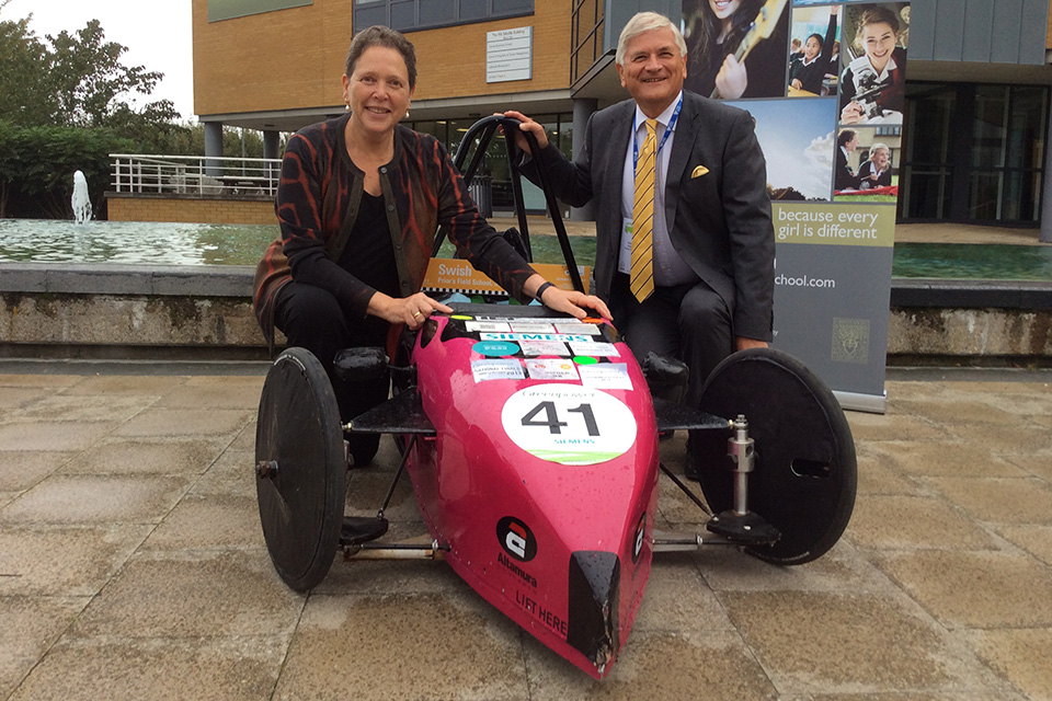 Baroness Kramer and green racing car.