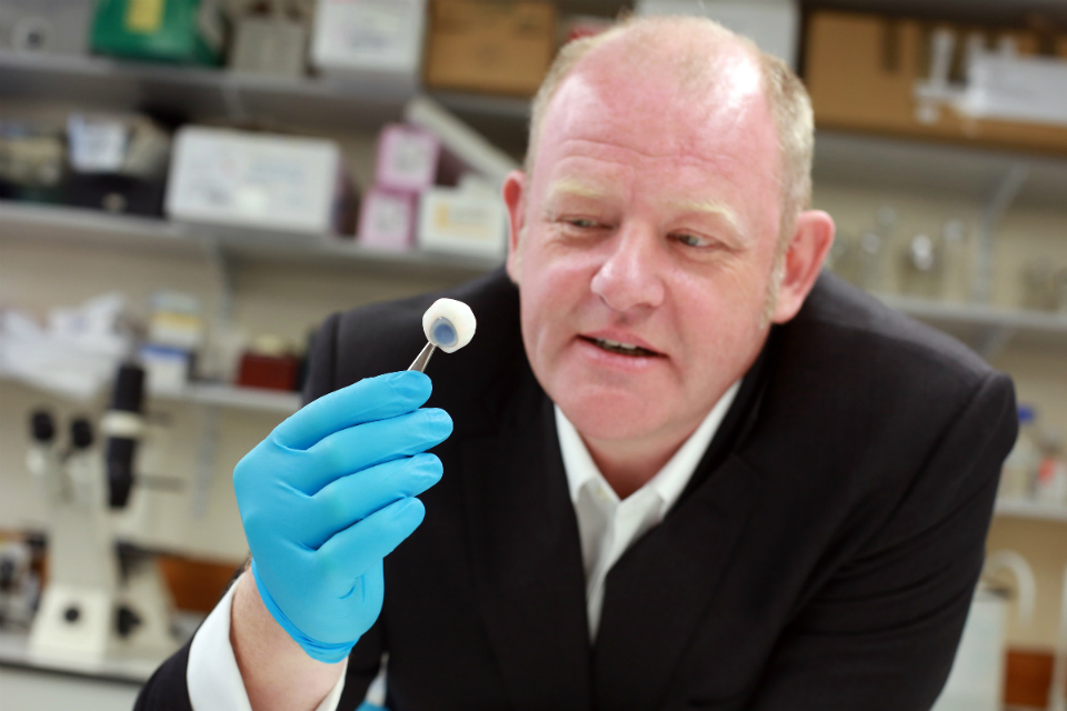 Richard Kirk holding a piece of electroluminescent material