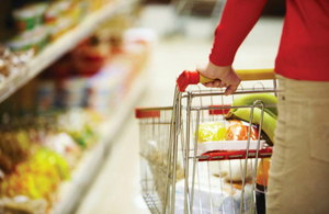 Woman pushing a shopping trolley in a supermarket