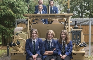 Students sitting on a Jackal armoured vehicle