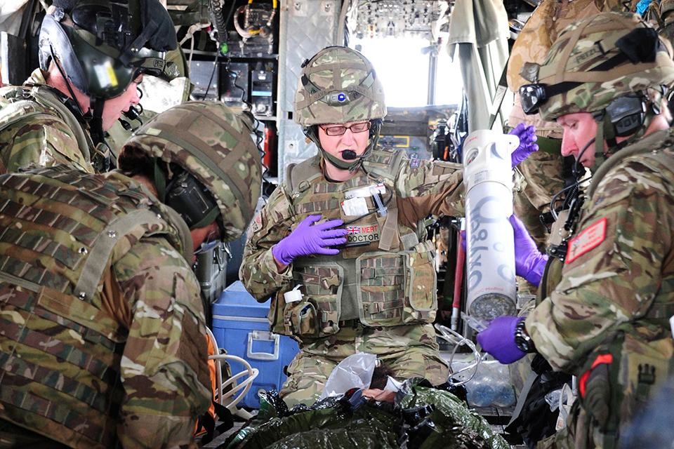 A casualty is tended to onboard a Chinook helicopter 