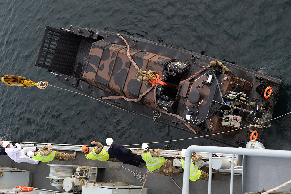 A landing craft is lowered from RFA Argus