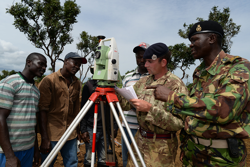 Sapper John Blackburn, Royal Engineers, discusses the build of a treatment centre with his Sierra Leone Armed Forces counterpart