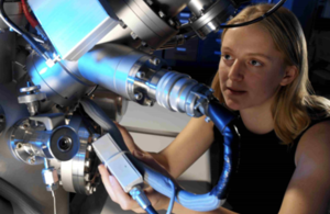 Woman scientist working on a mass spectrometer