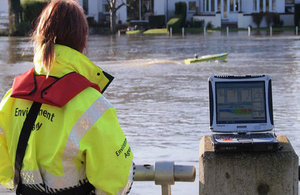 Environment Agency staff member using an arc boat on a river